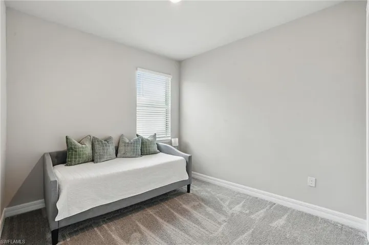 Bedroom with carpet flooring and baseboards