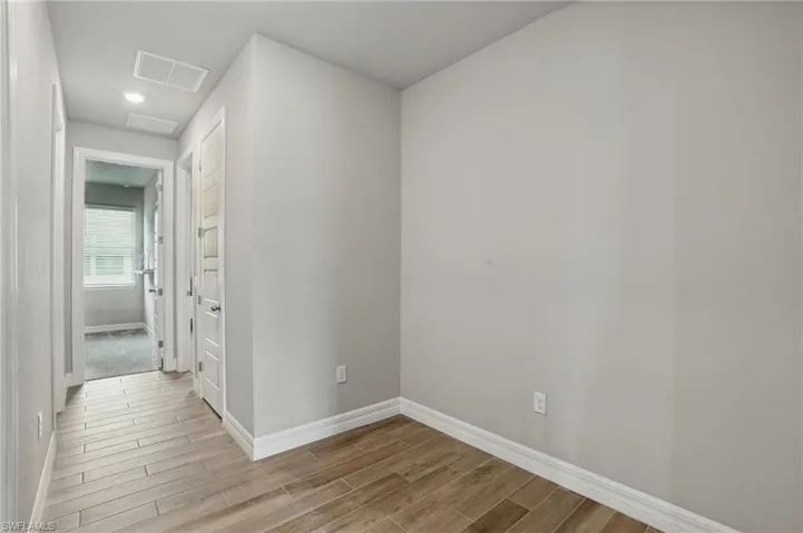 Hall featuring wood finished floors and baseboards