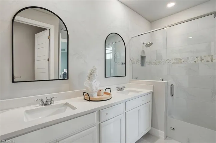Bathroom with a stall shower and double vanity
