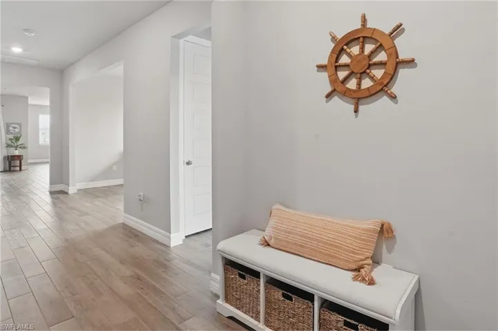 Mudroom with baseboards, wood finished floors, and recessed lighting