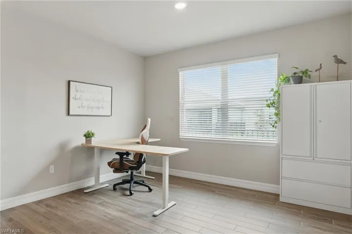 Office area with wood finished floors, baseboards, and recessed lighting