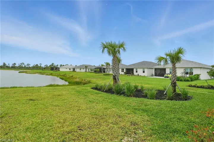 View of green lawn featuring a water view