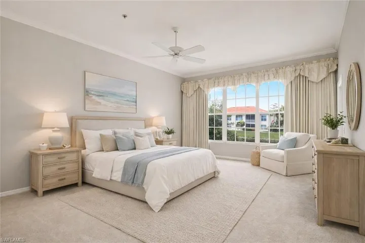 Virtually staged large primary bedroom with lake view