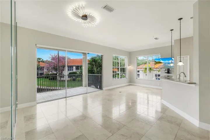 Bright living room with high ceilings and beautiful tile floors