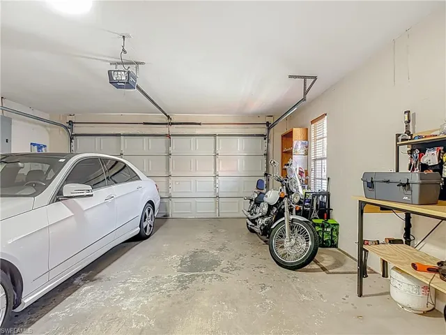 Garage featuring electric panel and a garage door opener