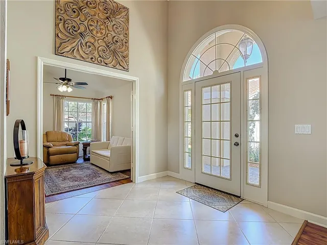 Entryway with light tile patterned floors, and a high ceiling