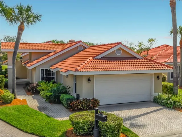 View of front of house featuring an attached garage, stucco siding, decorative driveway, and a tiled roof