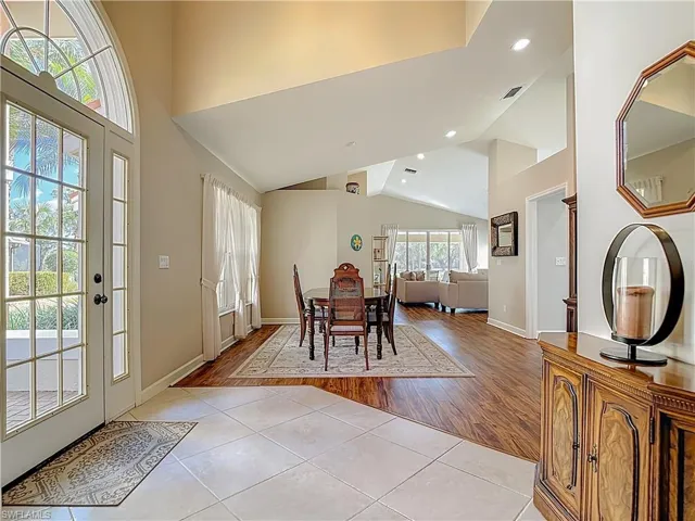 Dining area featuring light tile patterned flooring, recessed lighting, and vaulted ceiling