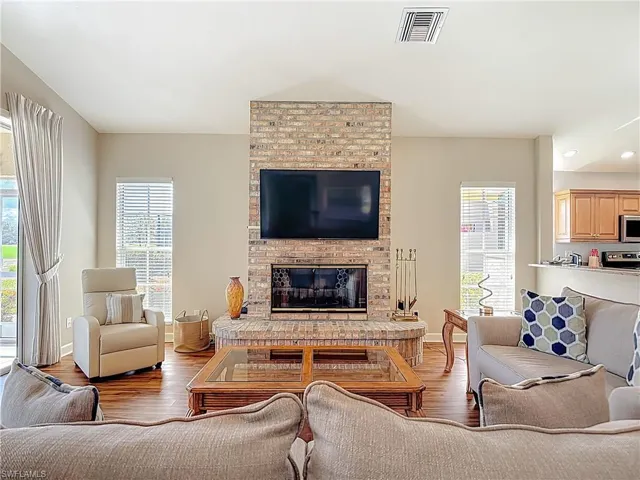 Living area featuring laminate floors and a fireplace