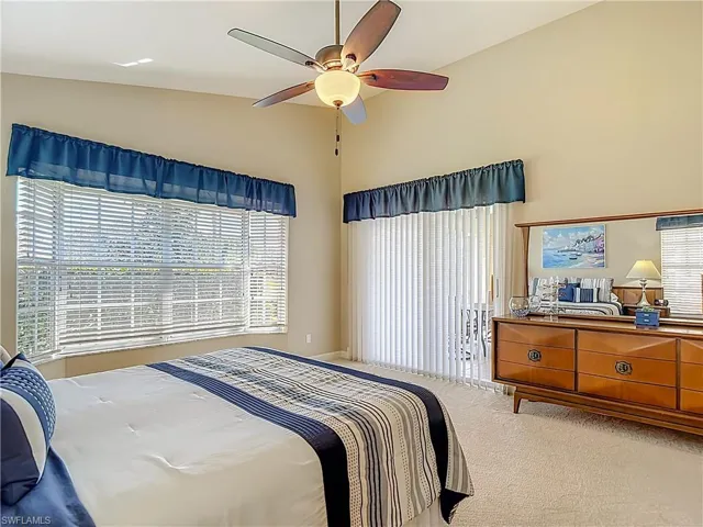 Primary Bedroom with multiple windows, carpet floors, and a ceiling fan