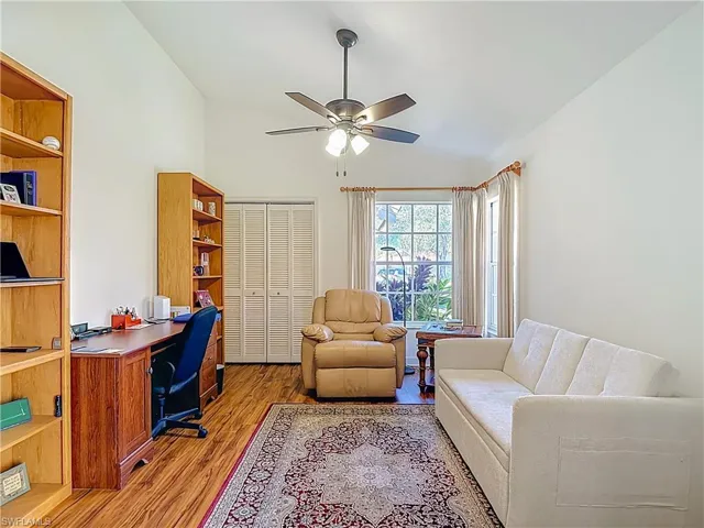 3rd Bedroom being used as an office with Laminate floors, vaulted ceiling, and a ceiling fan