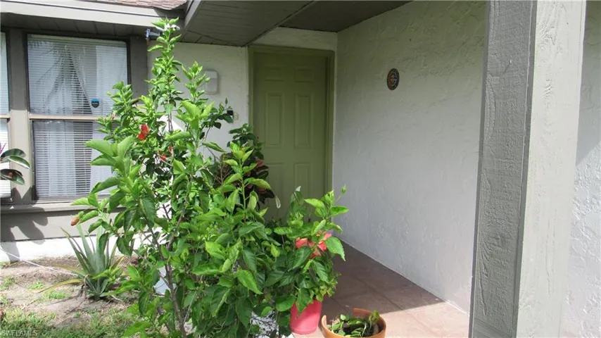 View of exterior entry featuring stucco siding