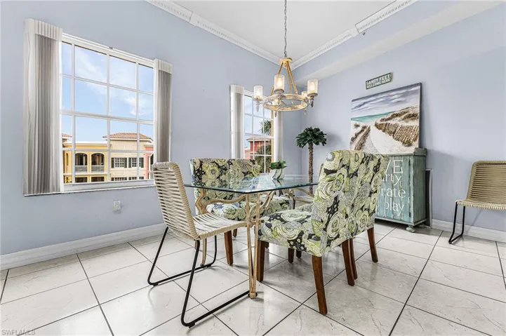Dining space featuring a chandelier and crown molding