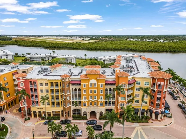 Bird's eye view of a nearby body of water and apartment complex / building
