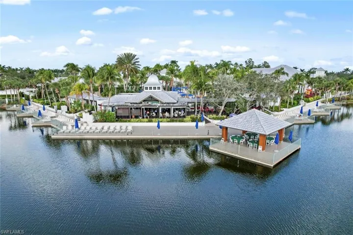 Dock area featuring a water view and view of wooded area