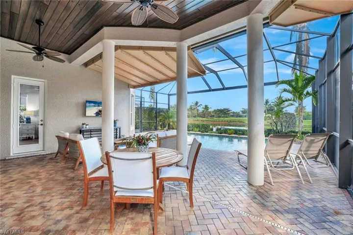 Sunroom featuring a patio area, ceiling fan, outdoor dining space, and healthy amount of natural light
