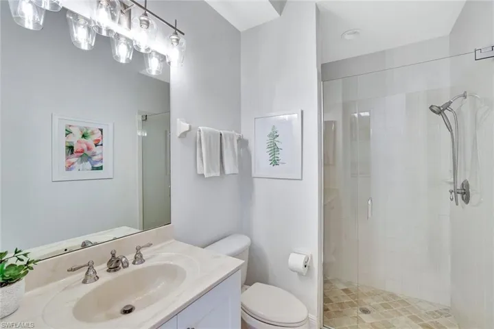 Full bath featuring vanity and a shower stall