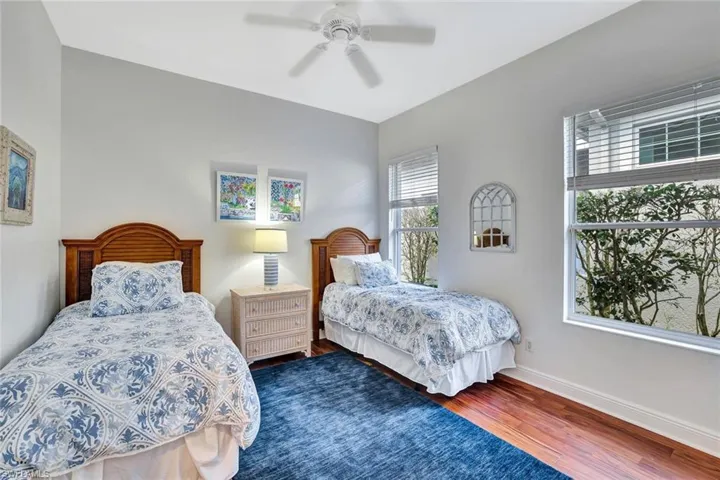 Bedroom with wood finished floors and a ceiling fan
