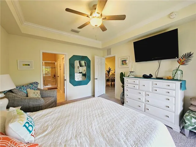 Master bedroom with crown molding & tray ceiling