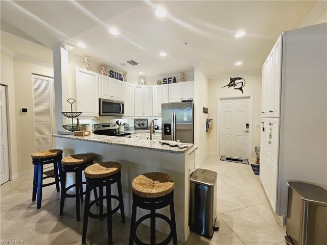 Your gourmet kitchen with granite countertops and stainless steel appliances