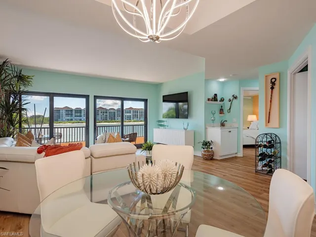 Dining space with light wood finished floors and a chandelier