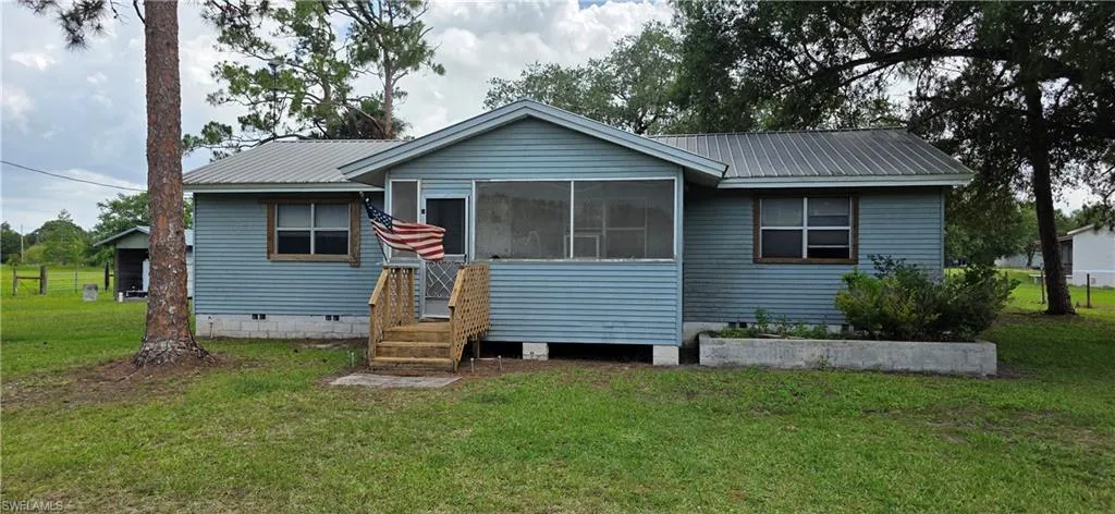 Light blue corrugated siding exterior with a metal roof