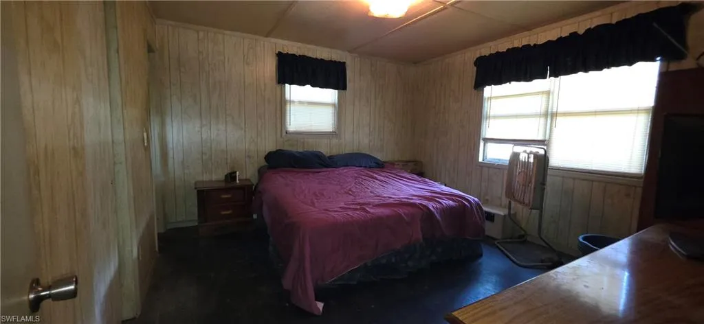 Room featuring paneled walls and dark flooring