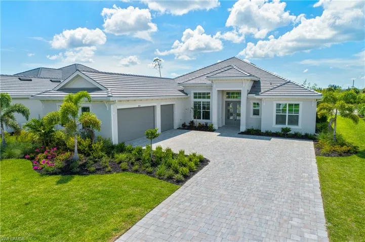 View of front of property featuring a garage and a front yard