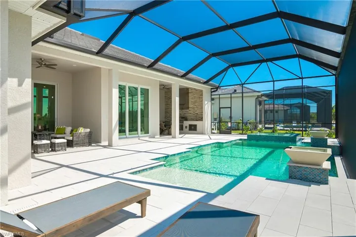 View of pool featuring a patio area, a lanai, and ceiling fan