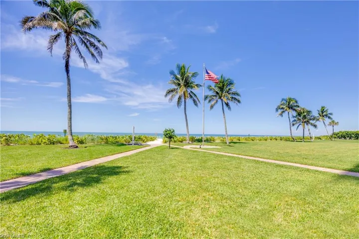 View of grassy yard with a water view