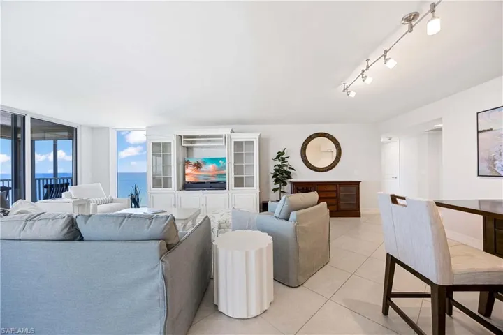 Living area with light tile patterned floors and baseboards