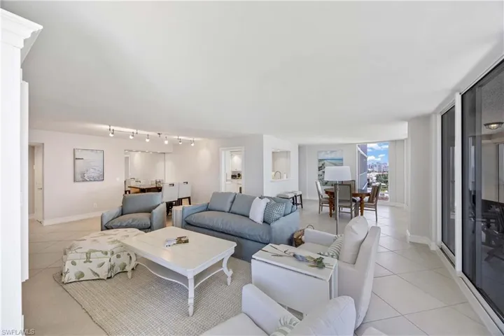 Living room featuring light tile patterned floors and track lighting