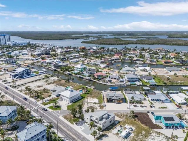 Aerial perspective of suburban area featuring a large body of water