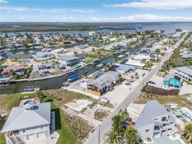 Aerial overview of property's location with nearby suburban area and a large body of water