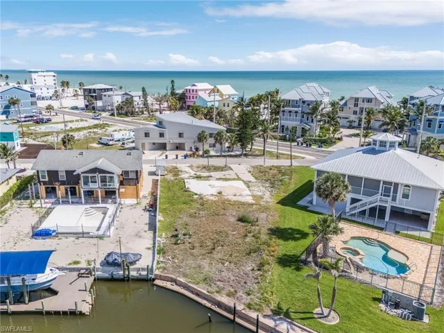 Drone / aerial view of a large body of water and a pool area