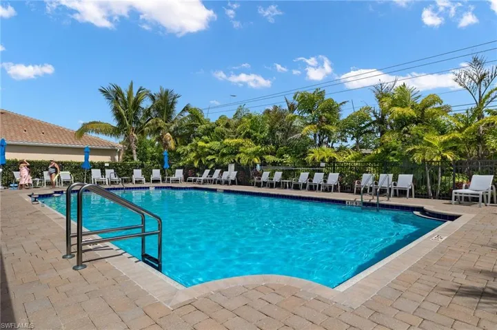 Community pool with fence and a patio