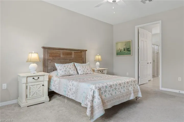 Bedroom featuring visible vents, baseboards, and light carpet