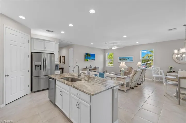 Kitchen featuring recessed lighting, stainless steel appliances, visible vents, light tile patterned floors, and a sink