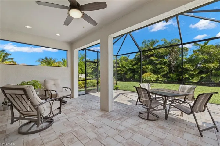 Sunroom / solarium with a ceiling fan and outdoor dining space