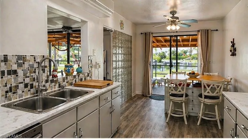 Kitchen featuring wood-finish flooring and a tiled backsplash