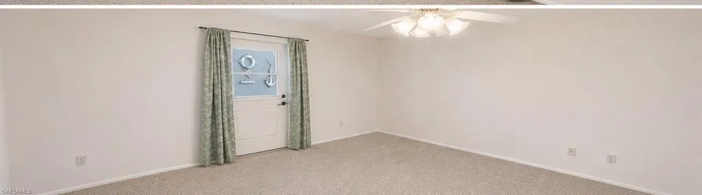 Light-toned wall-to-wall carpeting and neutral wall tones define this expansive interior space