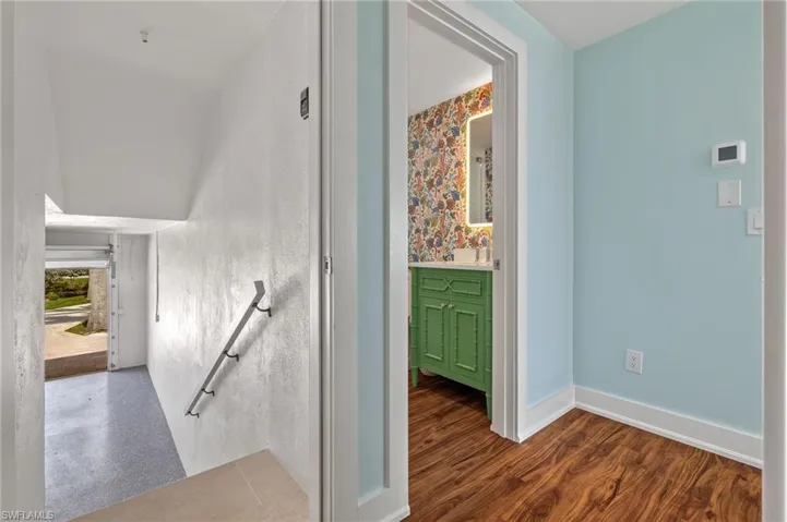 Stairs leading to garage with premium floor covering