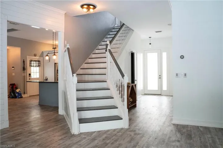 Dramatic staircase to upper level loft and bedrooms