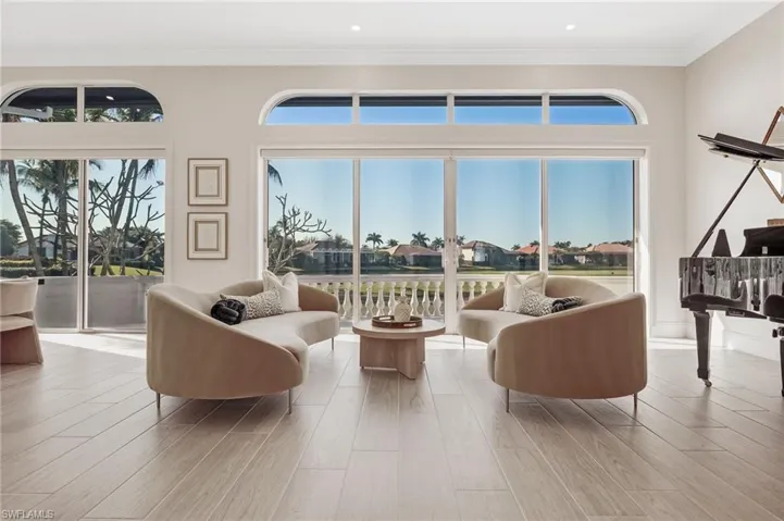 This is one of two inviting living areas, both showcasing beautiful views of the golf course and lake.