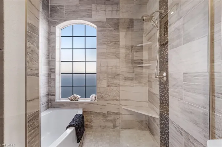 The third full bathroom, located in the in-law/casita suite, features a glass-enclosed tub and a separate walk-in shower for both style and convenience.