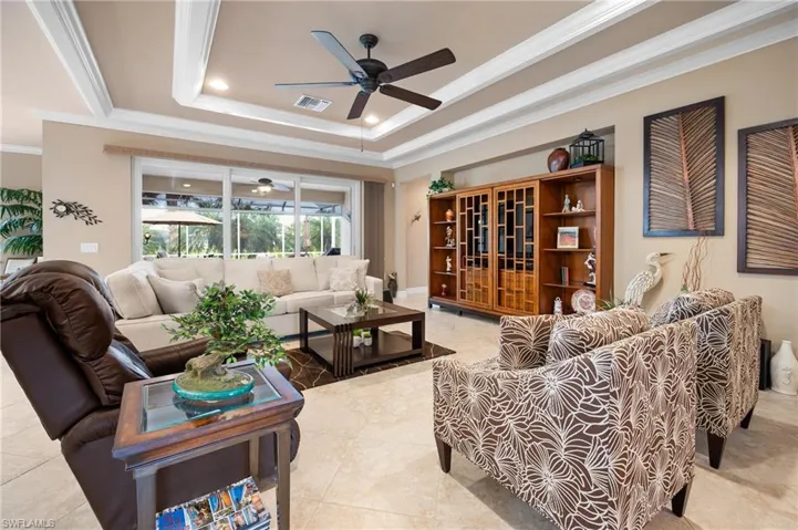 Living area featuring a coffered ceiling with recessed lighting and a ceiling fan