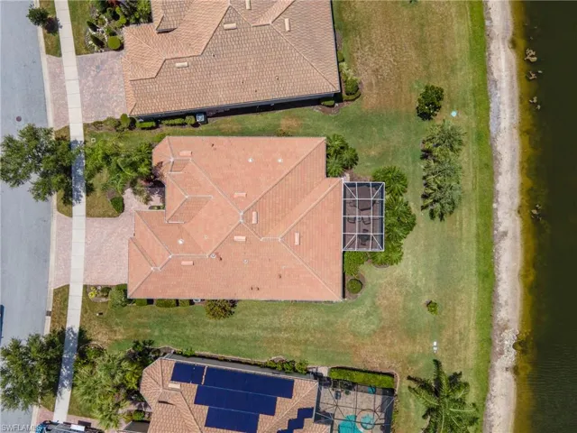 Terracotta tile roofing on a single-story residence featuring a screened-in lanai
