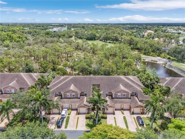 Aerial view of property and surrounding area featuring a large body of water