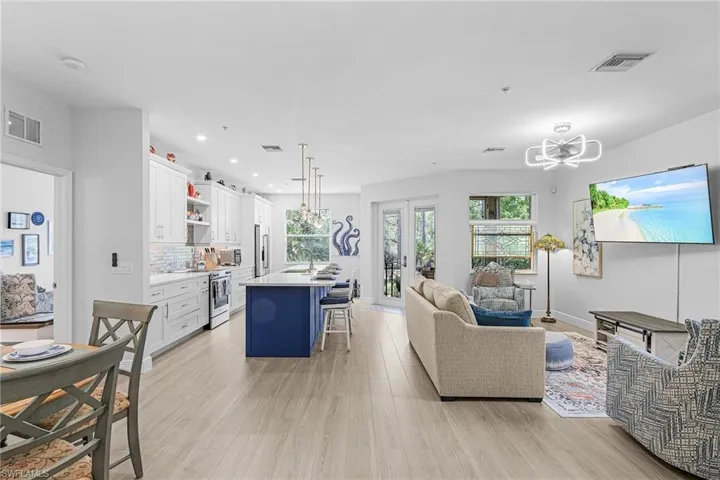 Living room featuring light wood-style floors, recessed lighting, french doors, and baseboards
