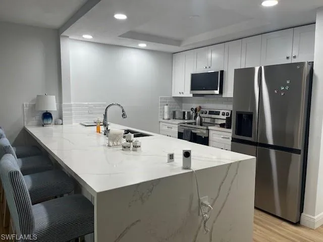 LARGE ISLAND WITH WATERFALL DESIGN, EXTRA CABINETS IN THE FRONT OF THE ISLAND FOR ADDED STORAGE